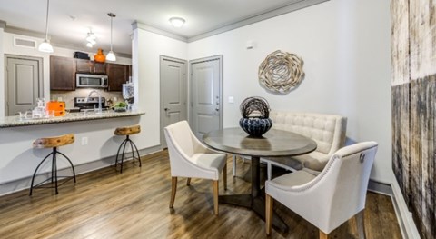 A kitchen with a white table and chairs.