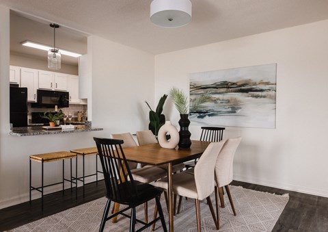 a dining room with a table and chairs and a kitchen