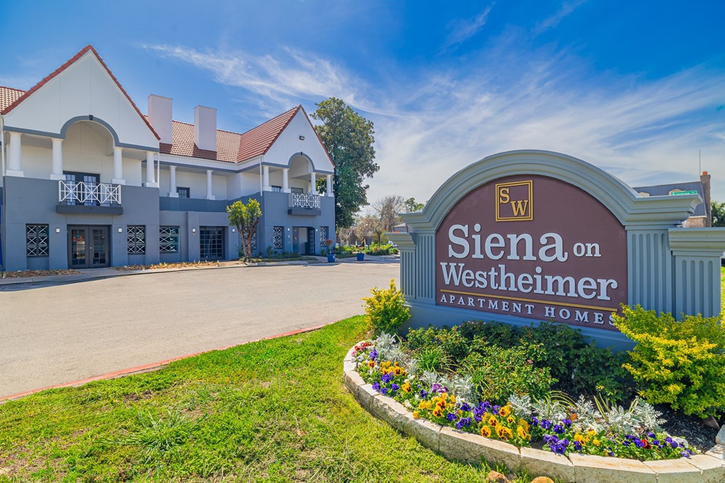 A sign for Siena on Westheimer Apartment Homes is in front of a building.
