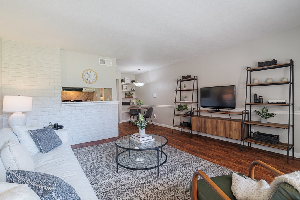 A living room with a white couch and a coffee table.