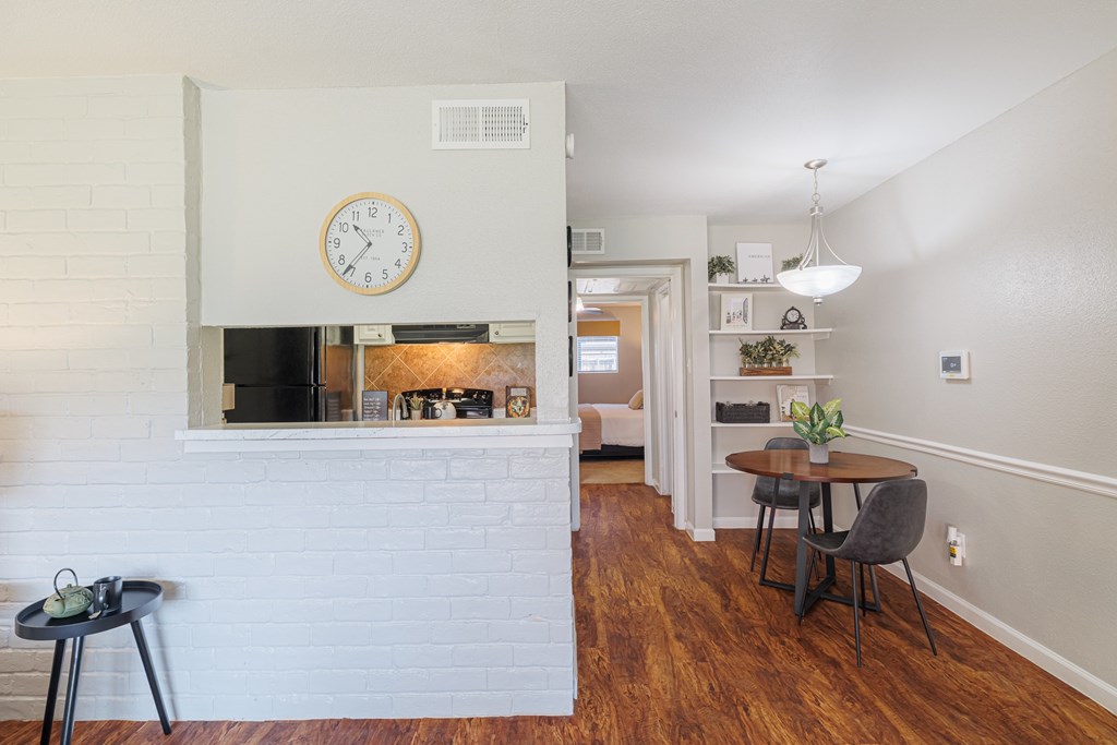 A white brick wall with a clock on it.