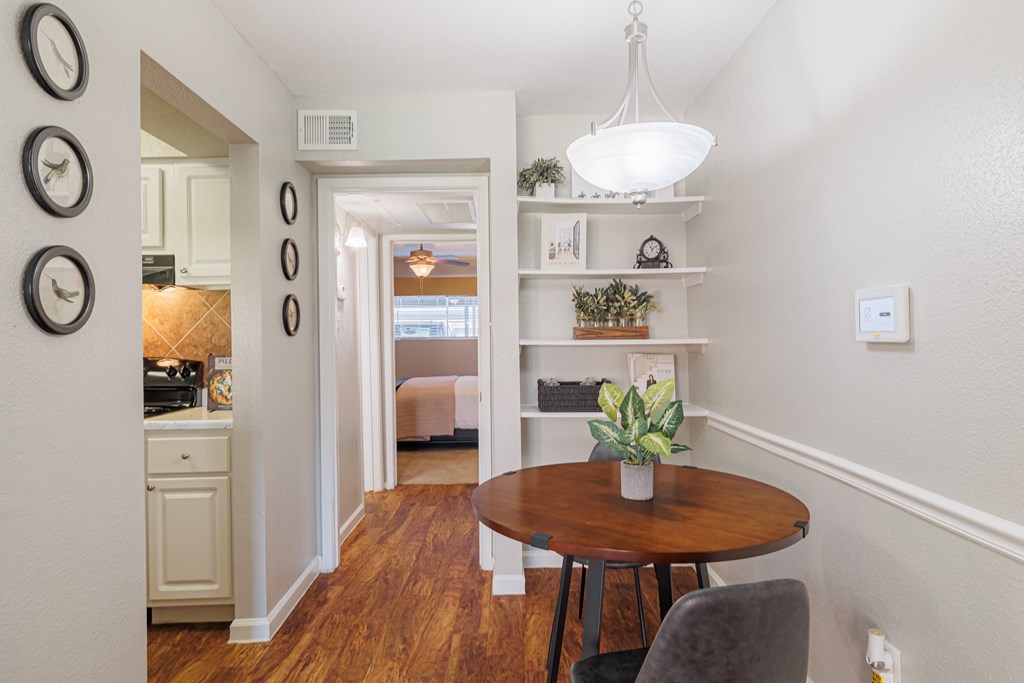A dining room with a table and chairs.