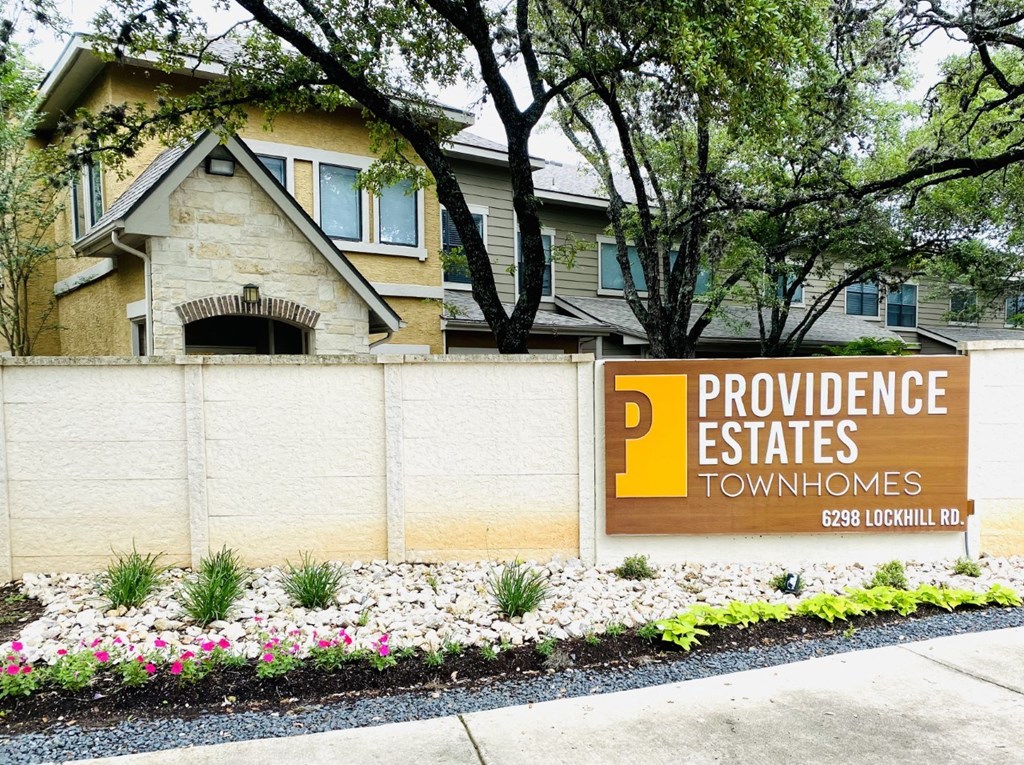 a sign in front of a house that says providence estates townhomes