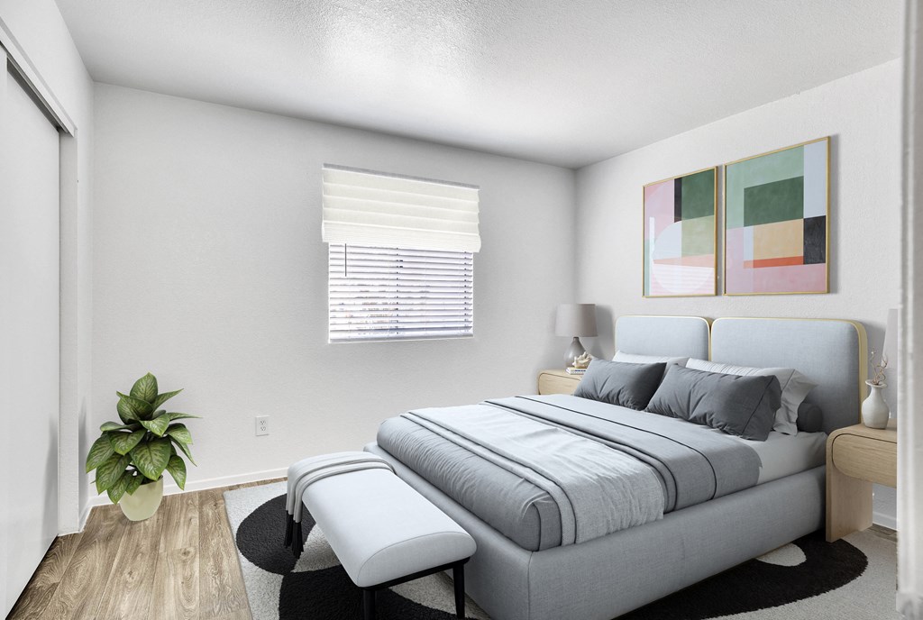 a bedroom with a bed and a chair and a plant