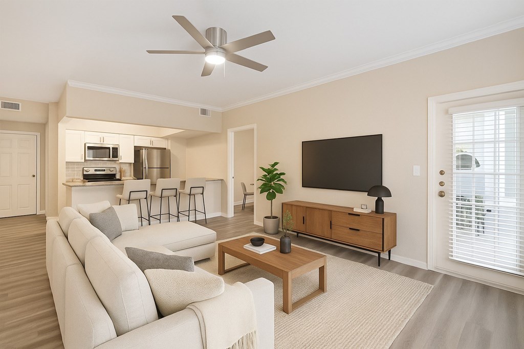 A living room with a white couch and a wooden coffee table.