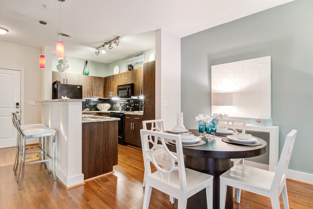 a kitchen and dining room with a table and chairs