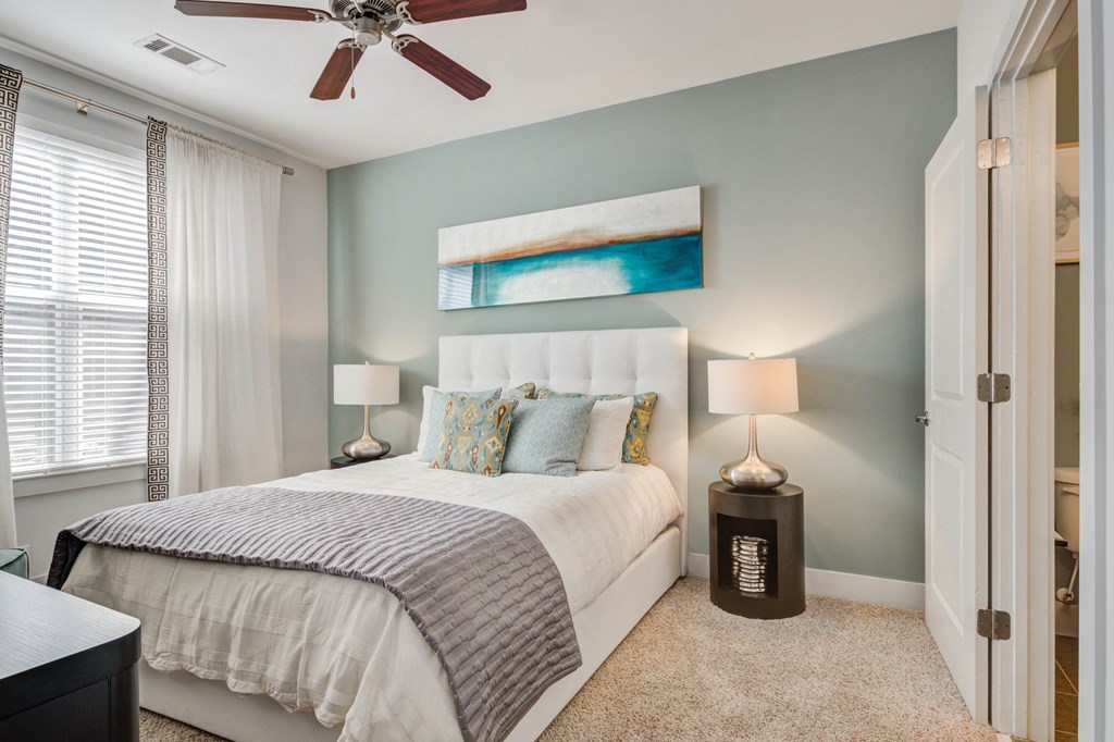 a bedroom with a bed and a ceiling fan
