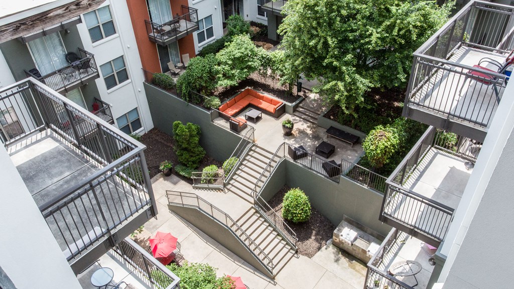 an aerial view of an apartment complex with stairs and a pool