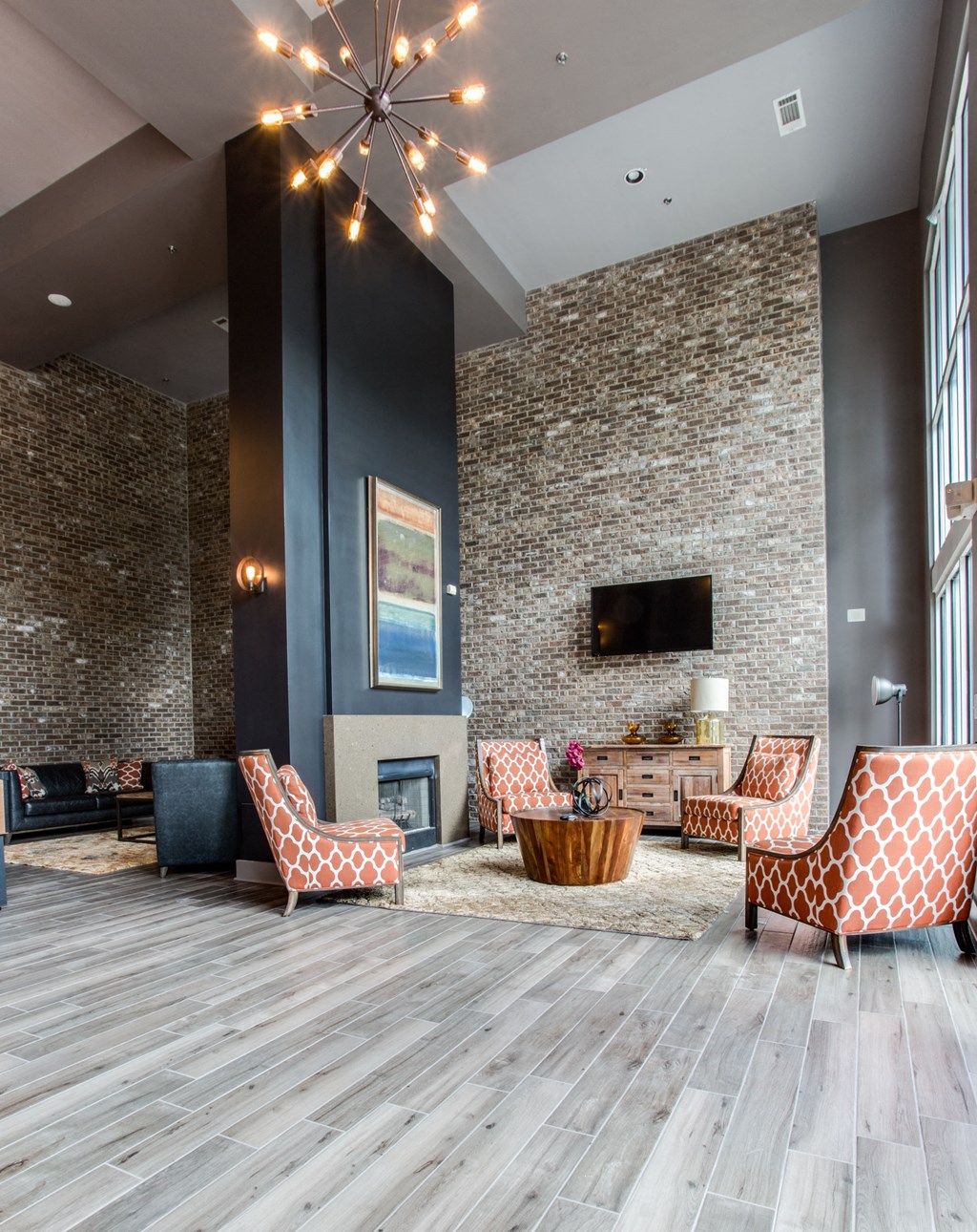 a living room with a fireplace and a large window