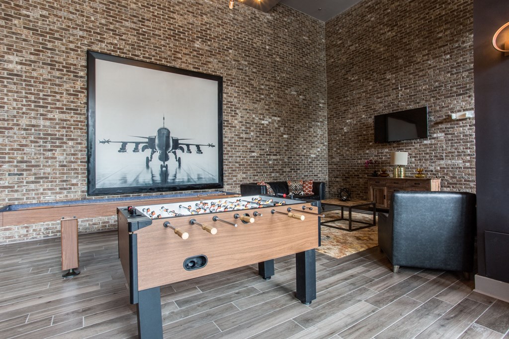 a games room with a foosball table and a large picture of an airplane