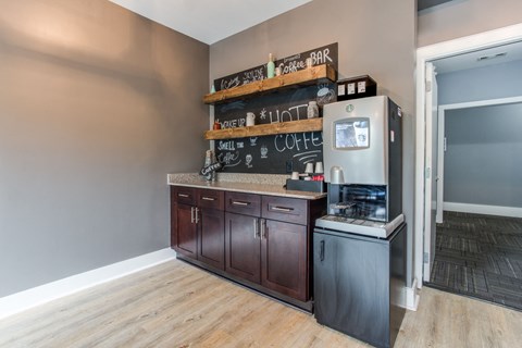a kitchen with wooden cabinets and a refrigerator and a counter top