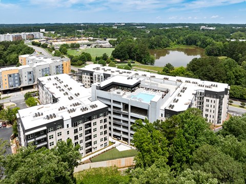 A large white building with a pool in the middle of it.