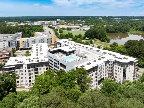 A large white building with a pool in the middle of it.