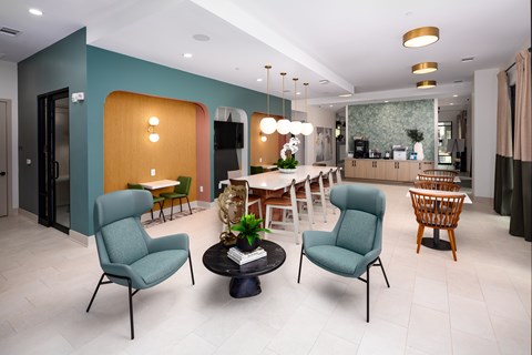 A living room with a green chair and a black table.