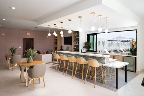 A modern kitchen with a dining table and chairs.