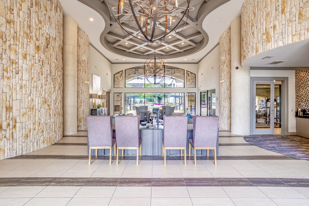 a lobby with a table and chairs and a chandelier