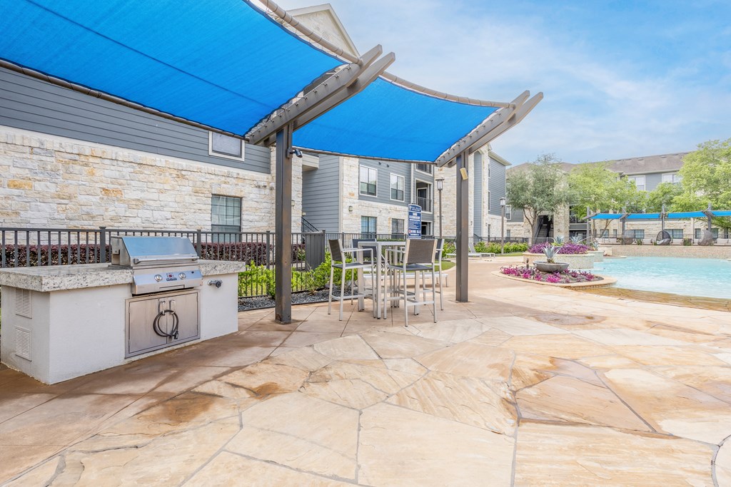 the preserve at ballantyne commons pool and patio with grill and table with chairs