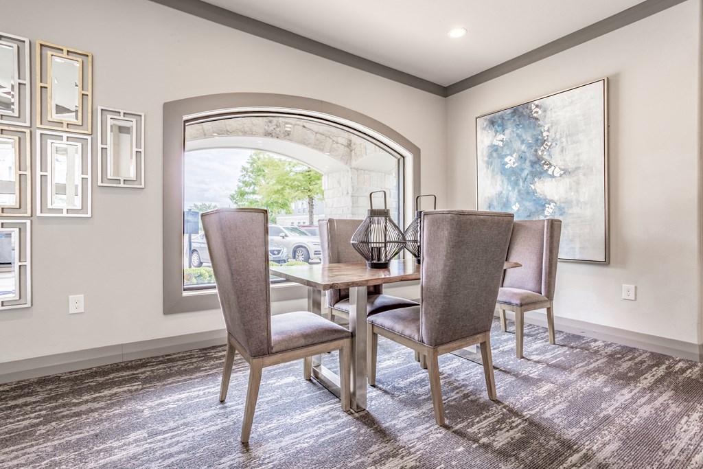 the retreat dining room with table and chairs and a large window