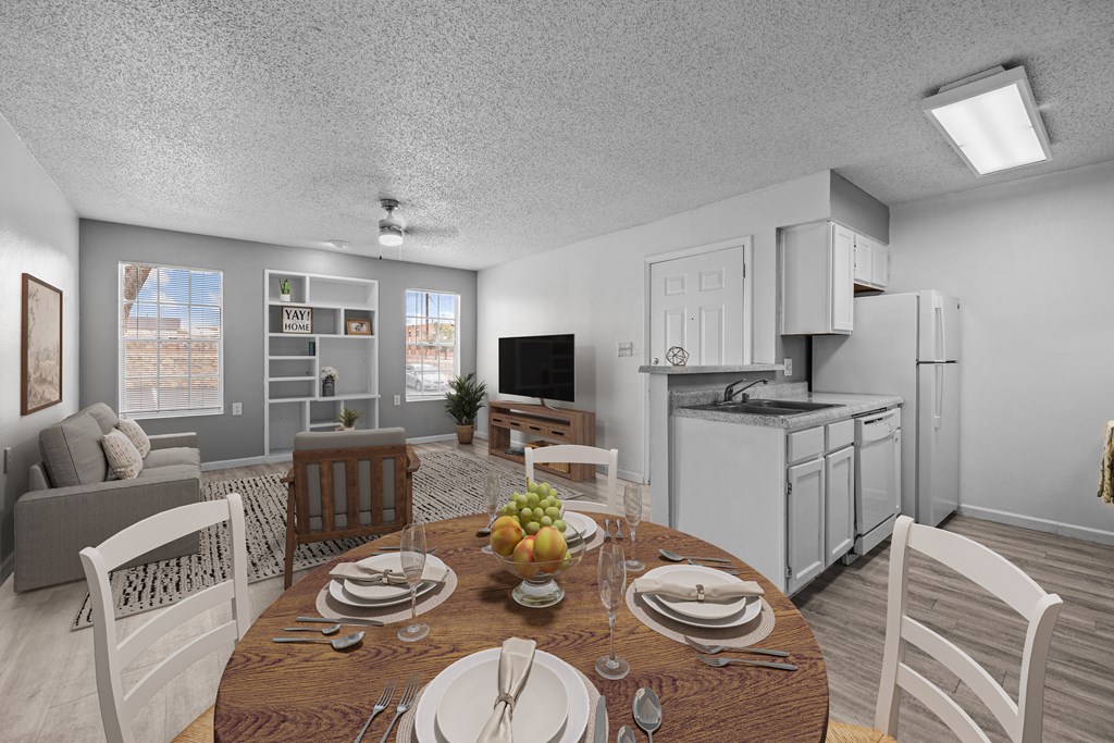 A dining room with a table set for a meal.