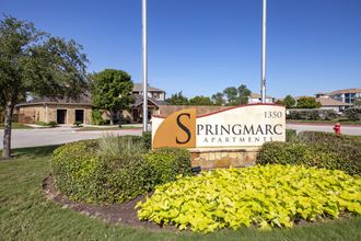 a sign that says springmar apartments with a sign in front of it