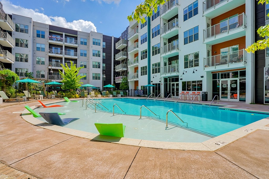 a swimming pool in front of an apartment building