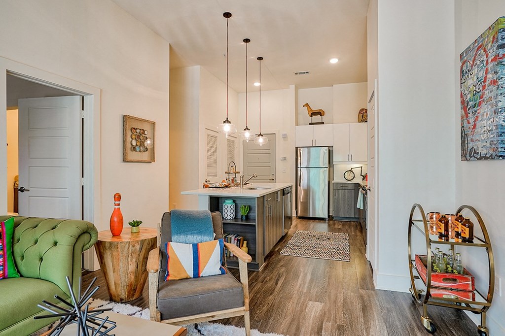 a living area with a couch chair and a coffee table