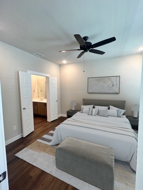 A bedroom with a large bed and a ceiling fan.