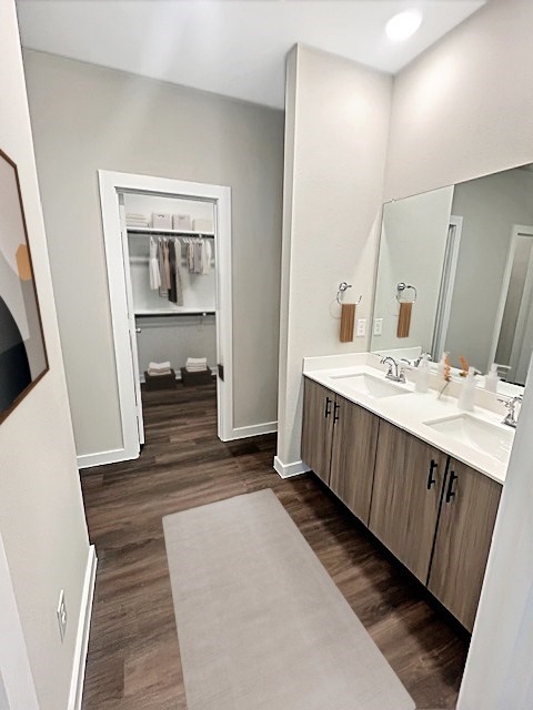 A bathroom with a white sink and a mirror.