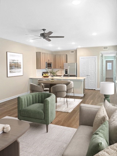 A living room with a green chair and a grey couch.