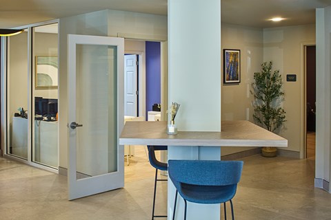 A modern dining room with a table and chairs.