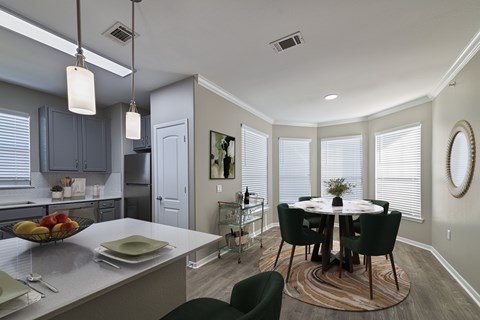 A kitchen with a table and chairs in the middle of the room.