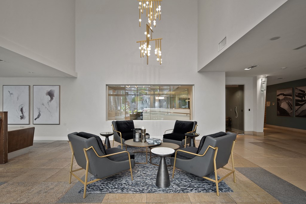 a living room with chairs and a table and a large window