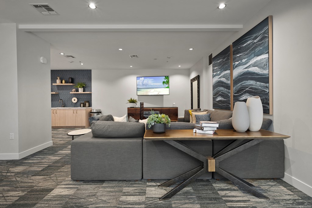 a living room with a gray couch and a wooden table