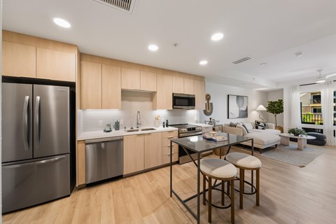 A modern kitchen with wooden cabinets and stainless steel appliances.