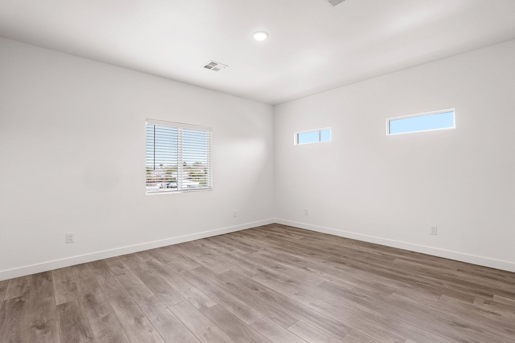 an empty room with white walls and a window