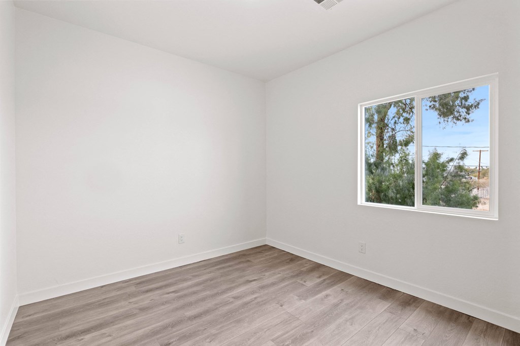 an empty room with white walls and a window