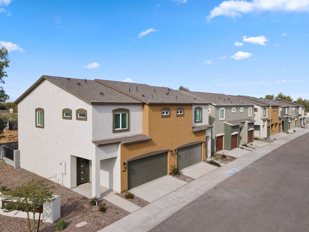 a row of town homes with garages and balconies