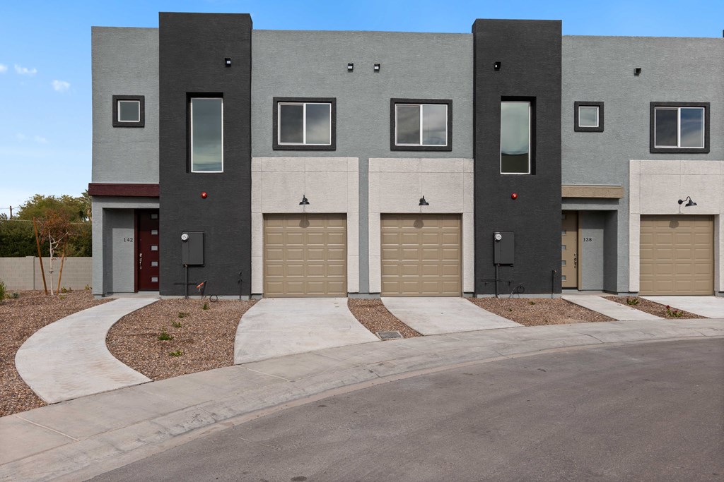 a view of a building with three garage doors