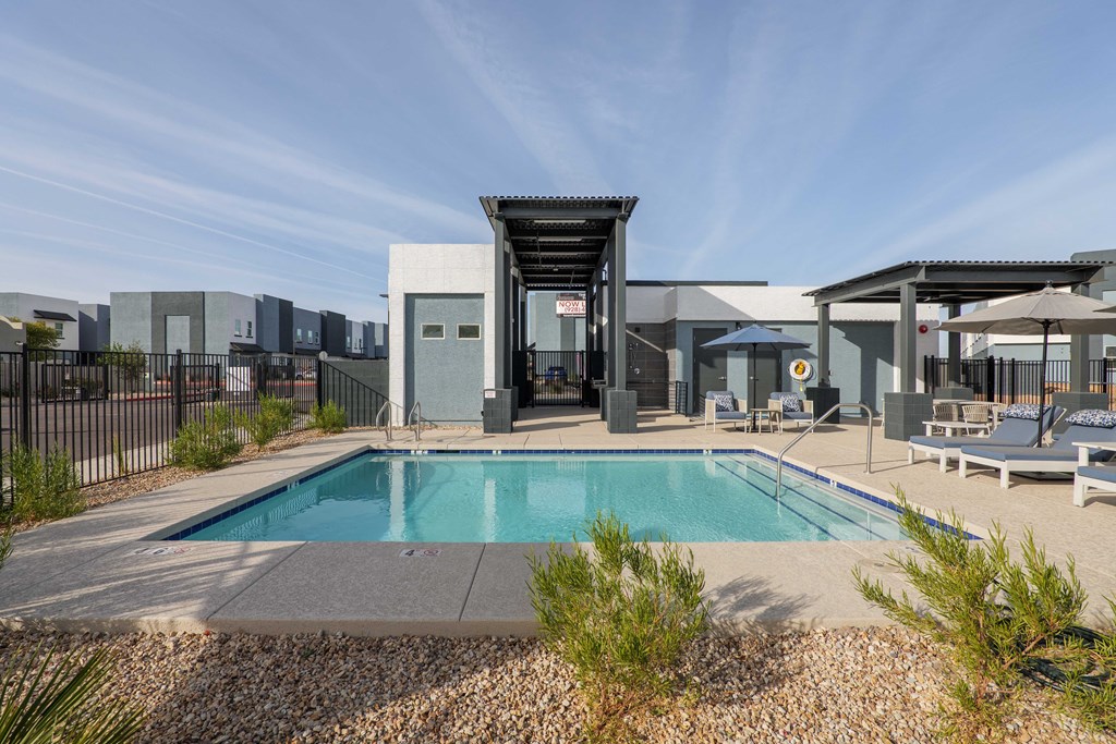 A modern house with a pool in the backyard.