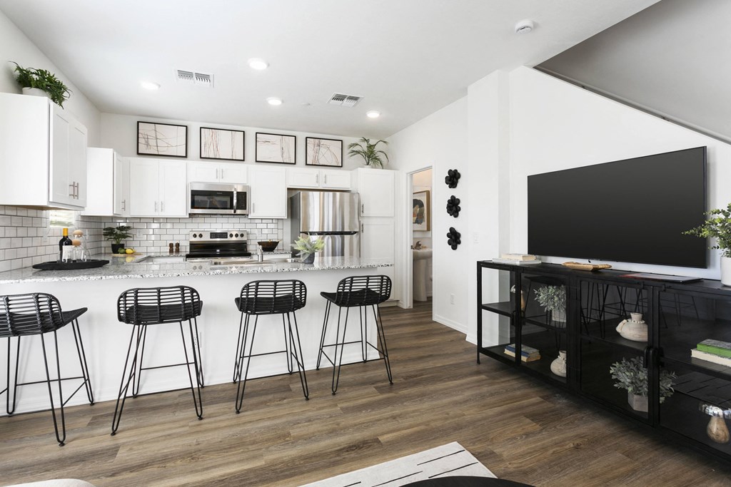 a living room with a kitchen and a tv
