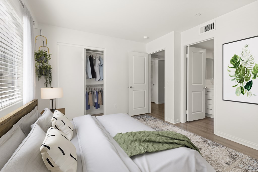 A bedroom with a large bed and a green blanket.