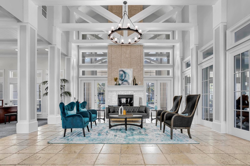 a living room with blue chairs and a fireplace