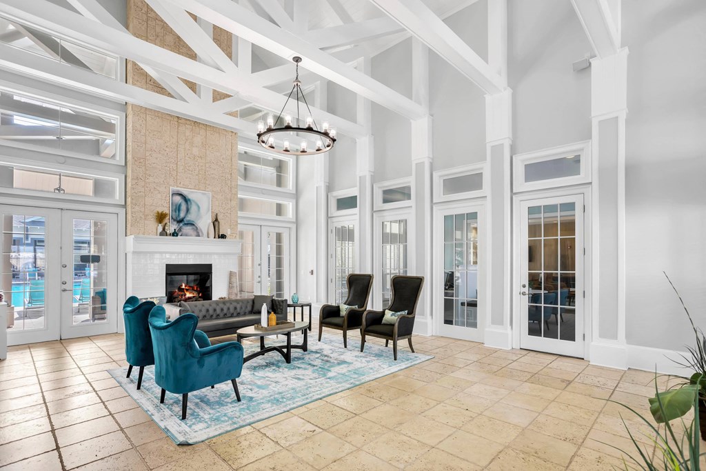 a living room with blue chairs and a fireplace