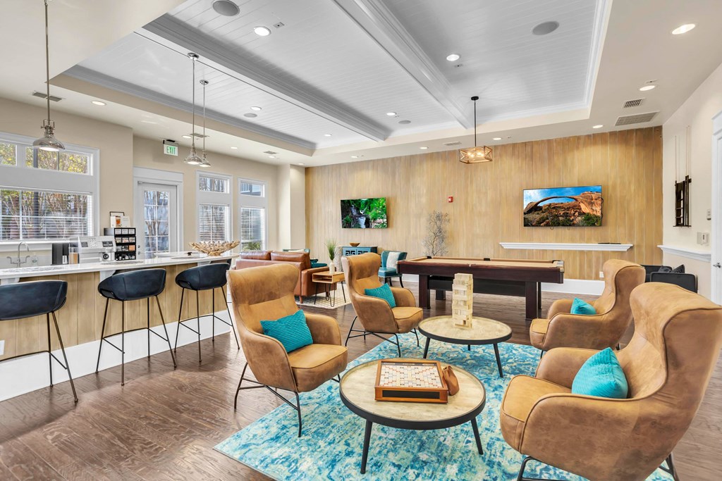 a living room with couches and chairs and a bar