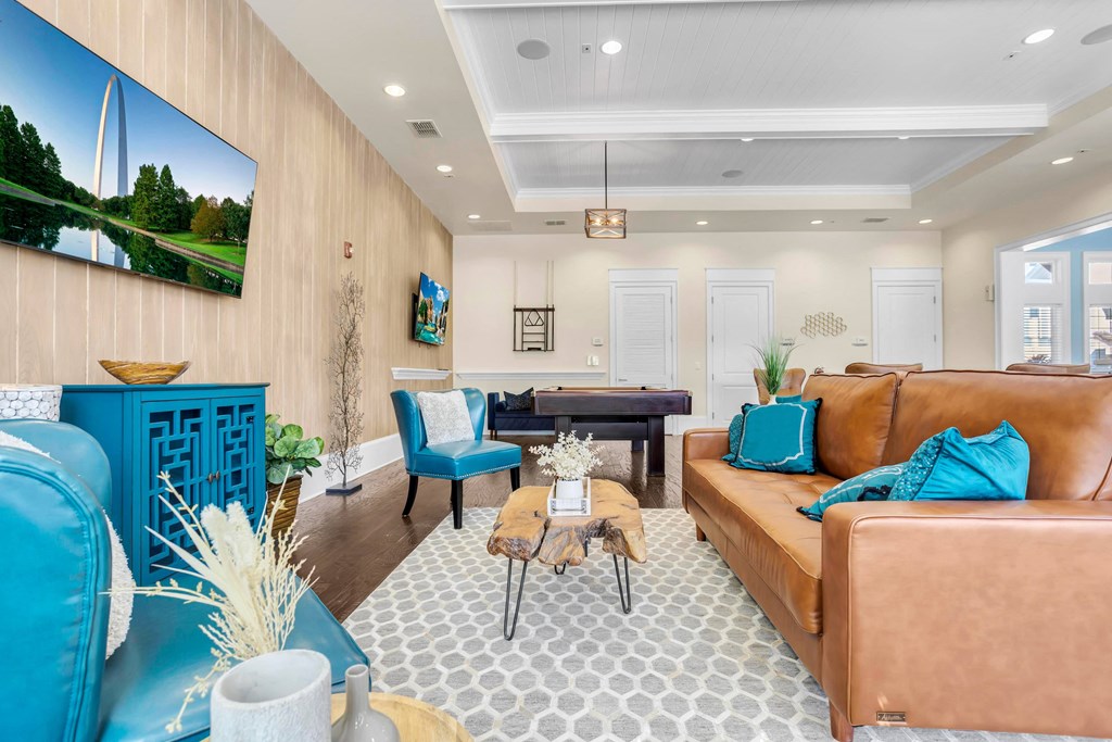 a living room with couches and chairs and a table