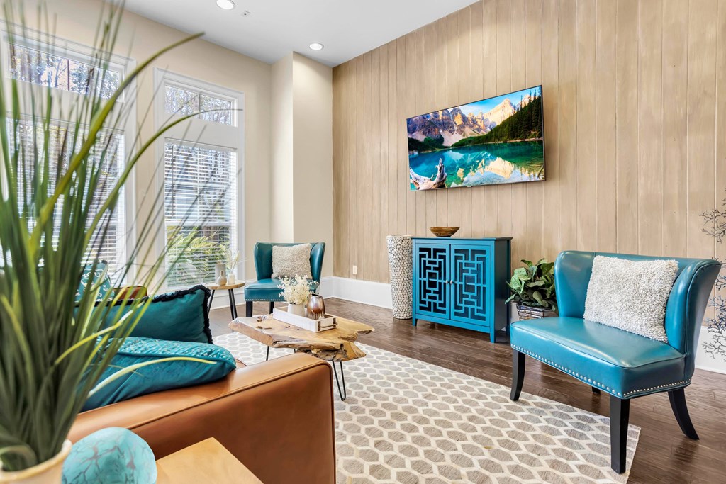 a living room with blue chairs and a couch