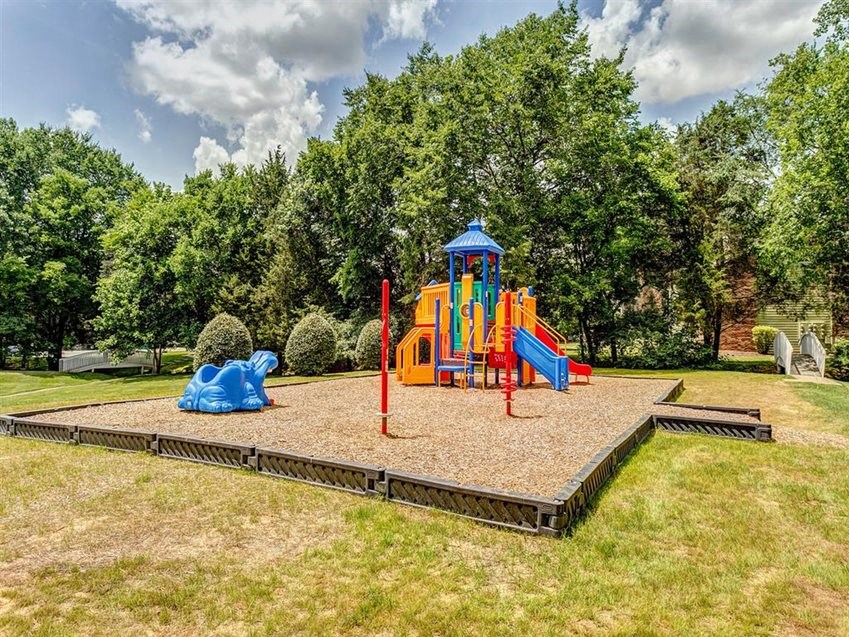 a playground with a blue and yellow swing set