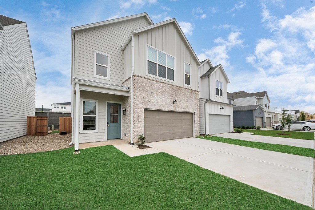 A house with a garage and a driveway.