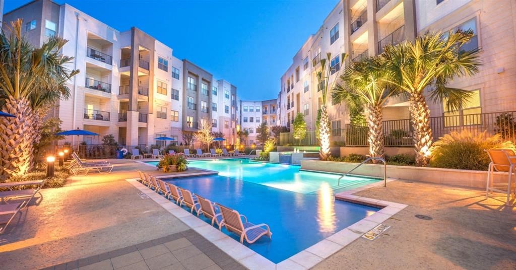 an apartment building with a large swimming pool