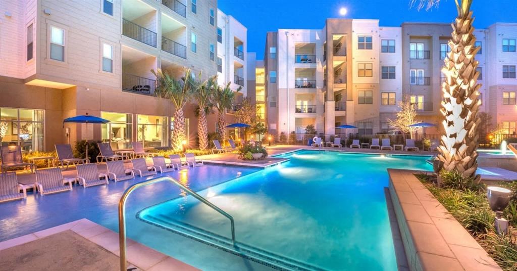 a swimming pool in an apartment building at night